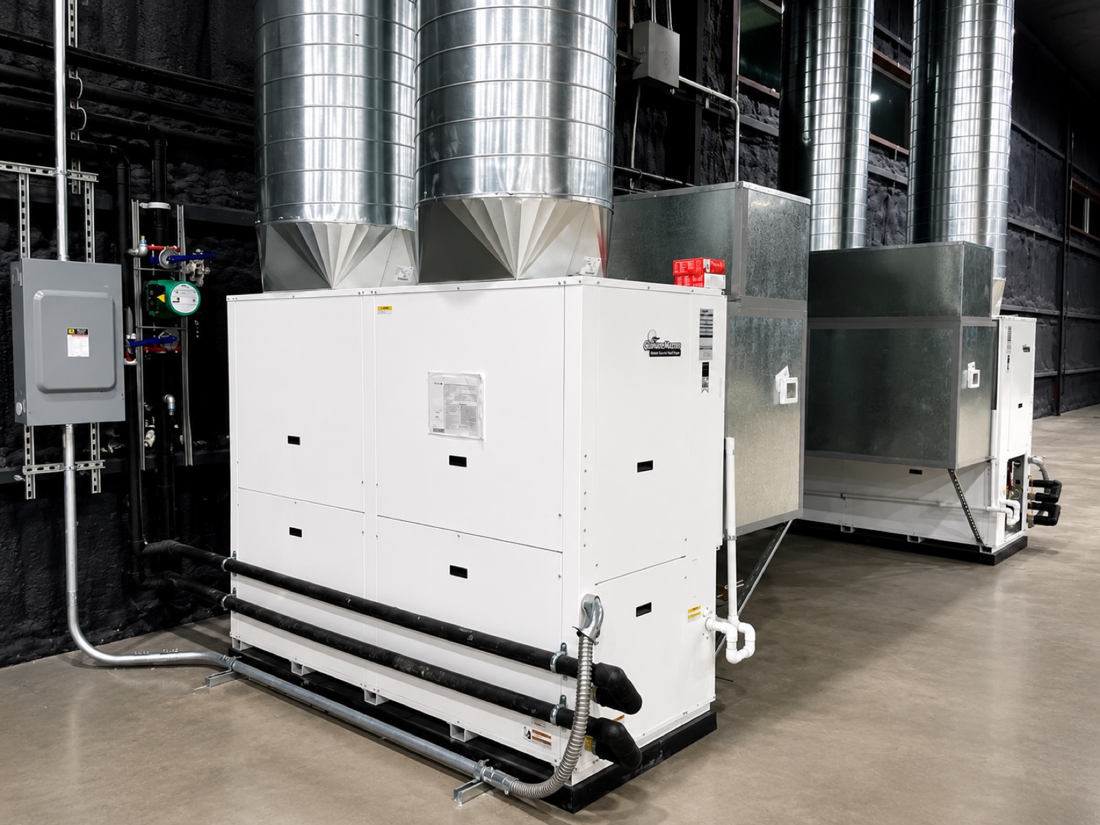 Row of WaterFurnace geothermal units installed along the mechanical alley at Home Run Alley in Lucas, Texas